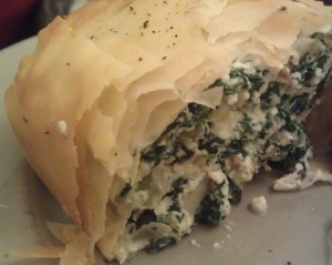 Slice of spinach and feta filo pie
